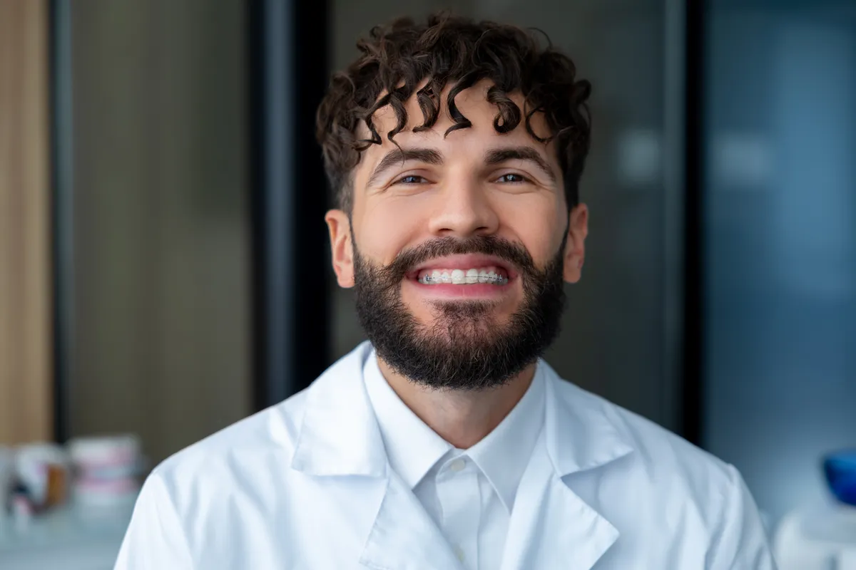A patient smiling with ceramic braces