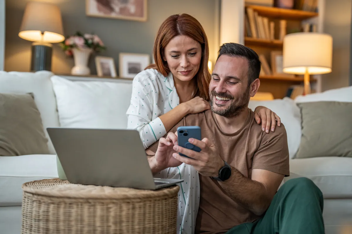 A couple reviewing finance paperwork together at home