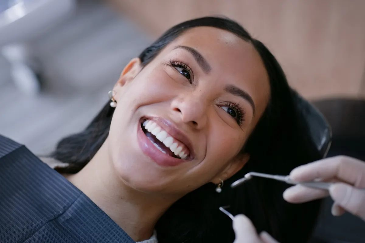 A patient smiling during a consultation in the dental chair