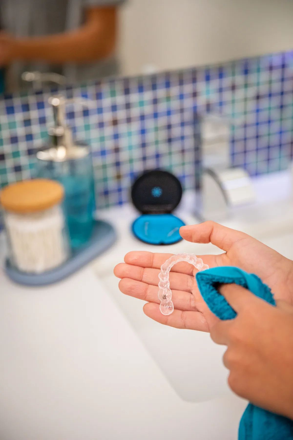 A patient placing her Invisalign® aligner back in its case
